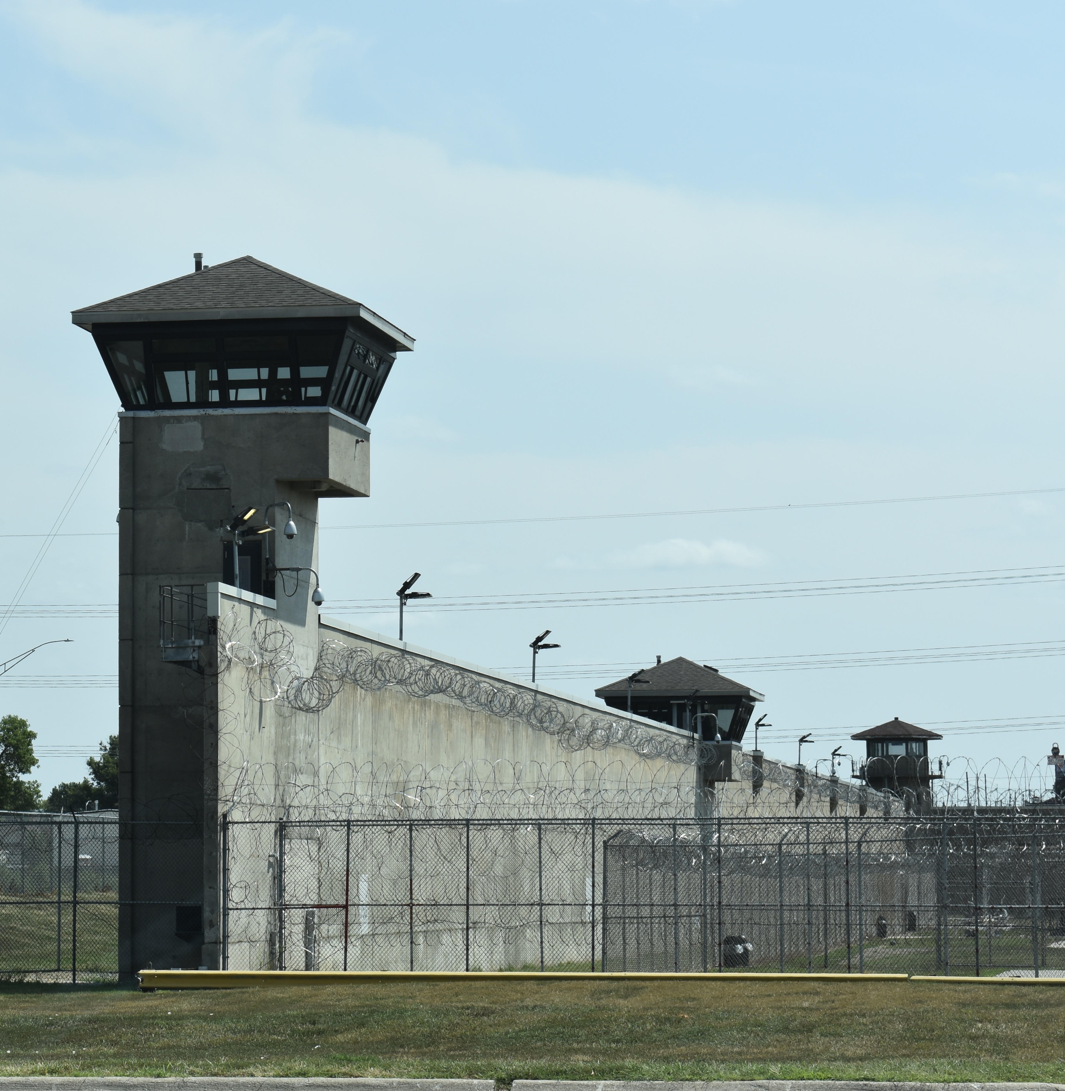 Grey prison walls with guard towers